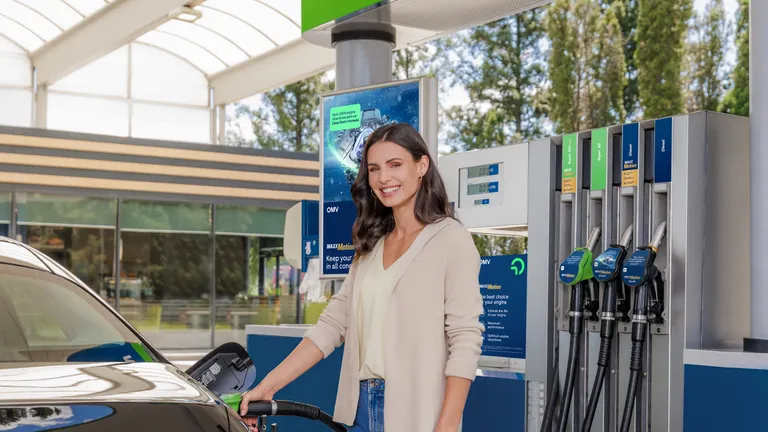 Woman fueling a car